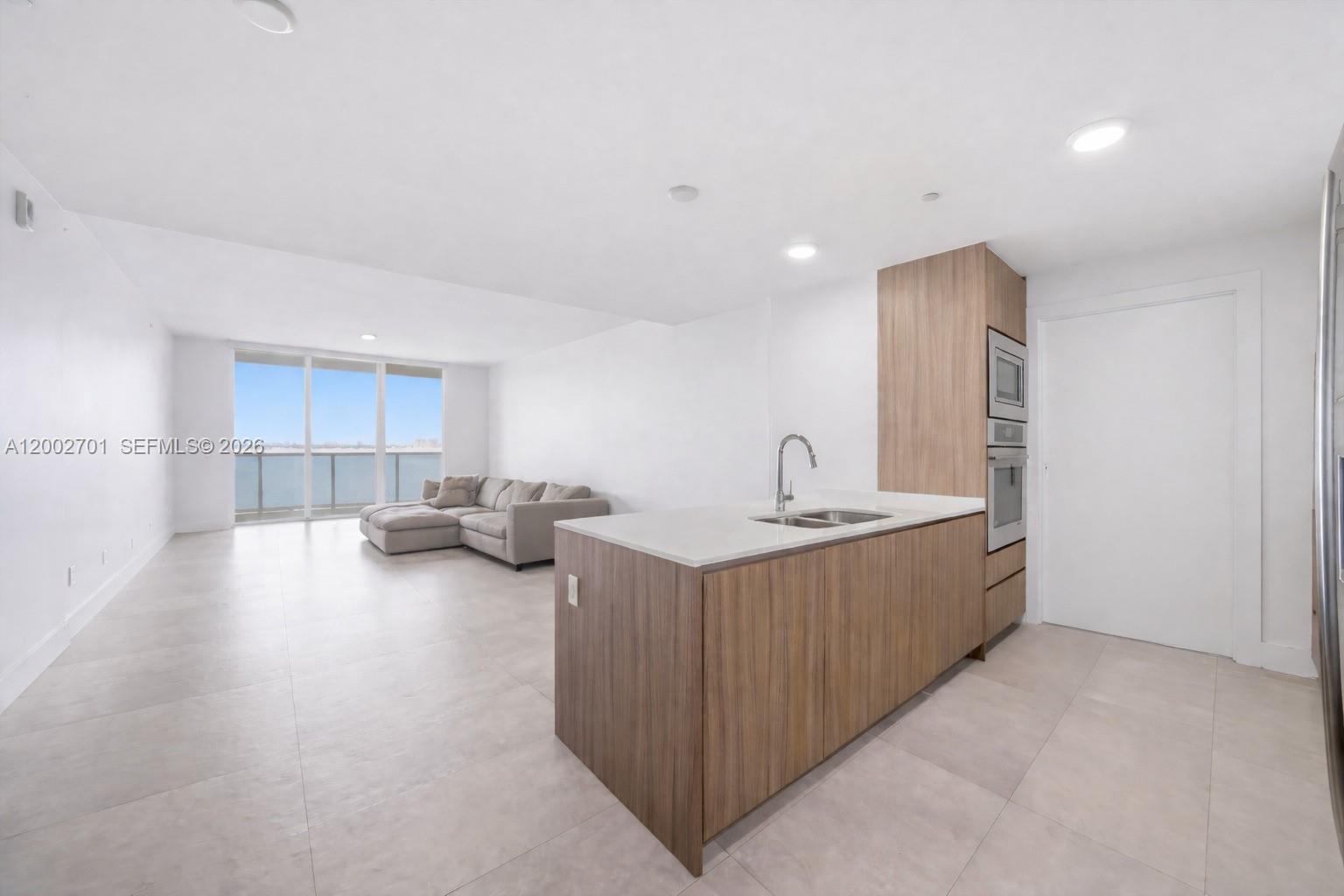 600 Northeast 27th Street, Unit 1002 Miami, FL 33137 - Photo 10 of 30 a living room with furniture and a large window