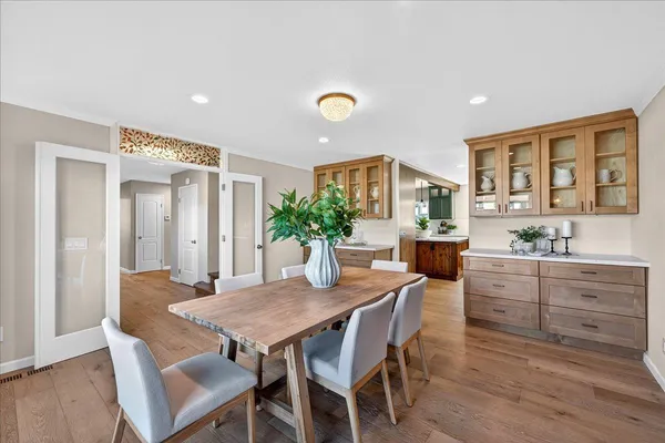a kitchen with stainless steel appliances kitchen island granite countertop a refrigerator a oven and a sink