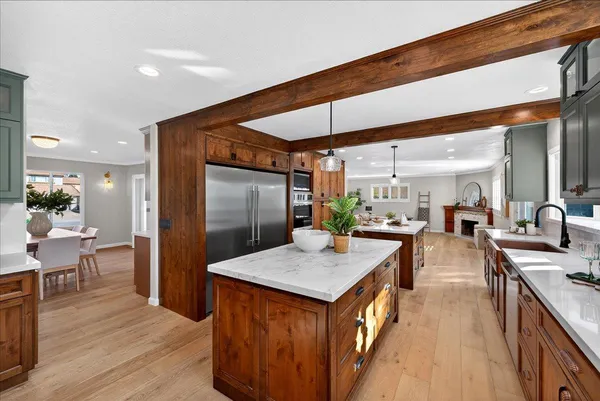 a large kitchen with kitchen island a large counter space sink and large window