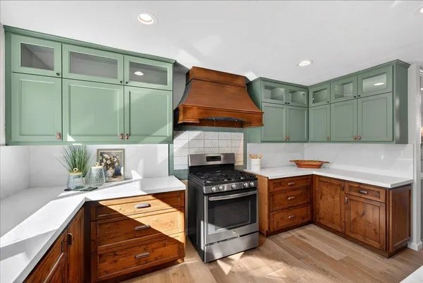 a kitchen with stainless steel appliances granite countertop lots of counter top space and wooden floor