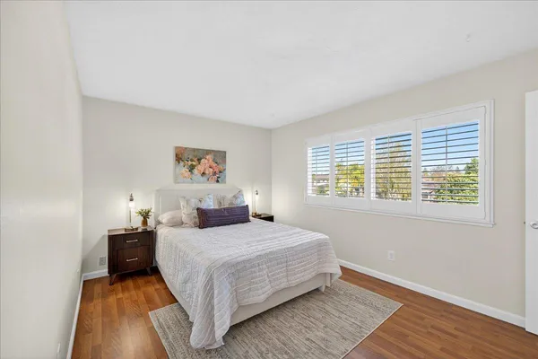 a view of a patio with couches table and chairs and potted plants
