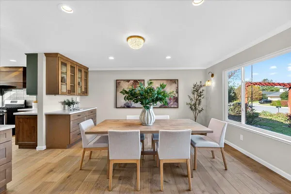a view of a dining room with furniture window and wooden floor