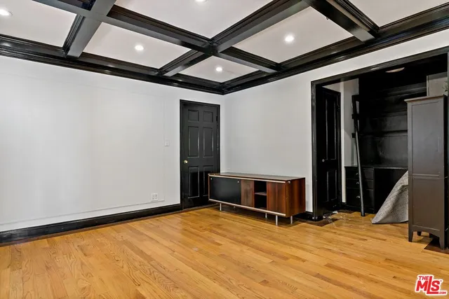 a view of a room with wooden floor