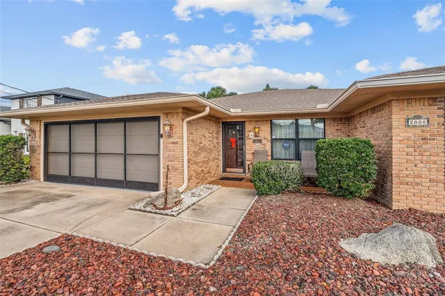 a view of a porch with a table and chairs and potted plants