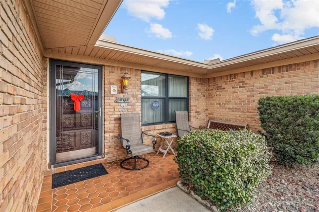 a view of a hallway with wooden floor and a chandelier