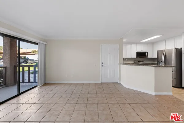 a view of kitchen with stainless steel appliances granite countertop a refrigerator sink and cabinets