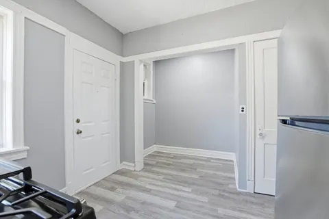 a view of a room with wooden floor