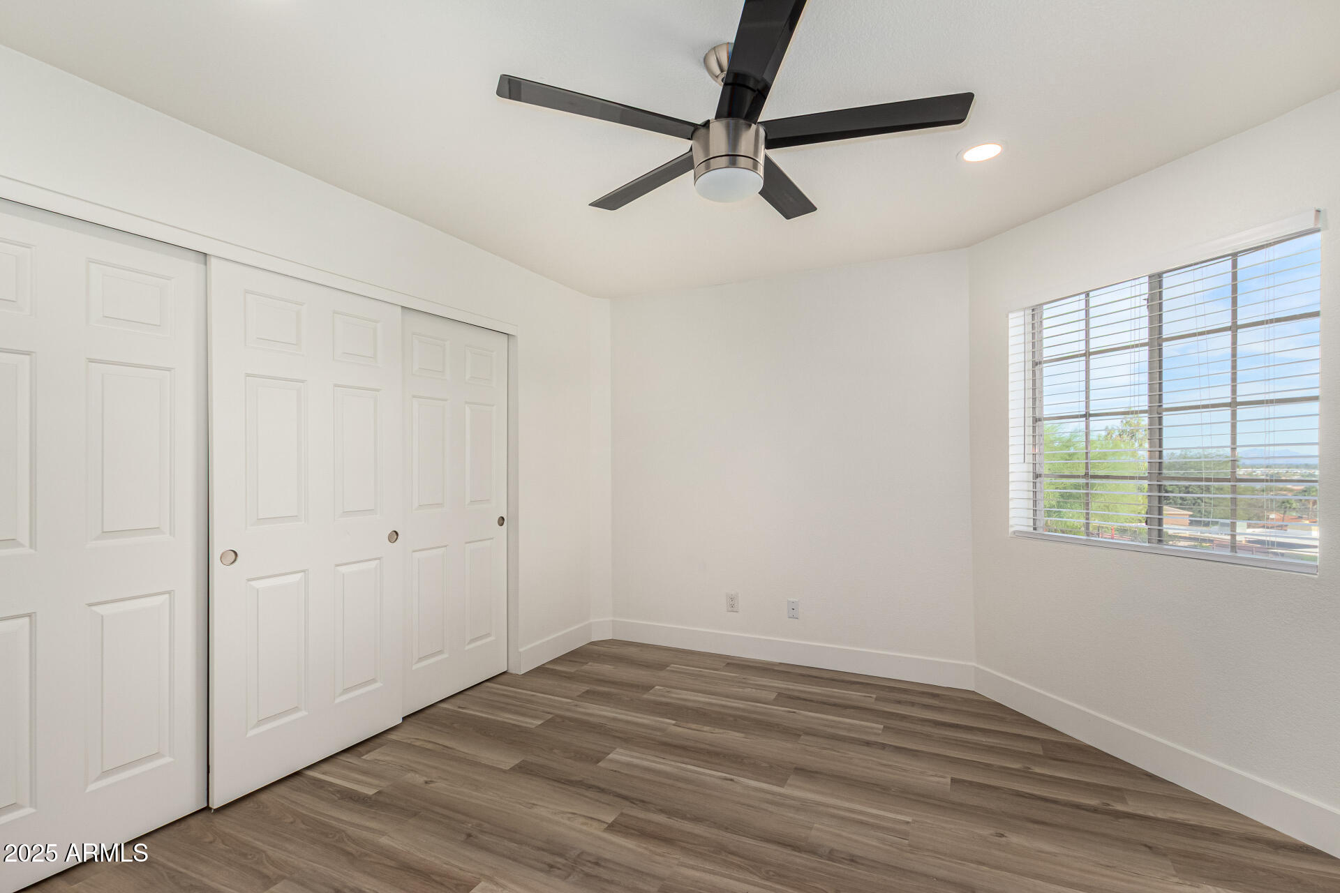 1720 East Thunderbird Road, Unit 2044 Phoenix, AZ 85022 - Photo 11 of 22 an empty room with wooden floor fan and windows