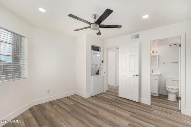 a view of a livingroom with a hardwood and a ceiling fan