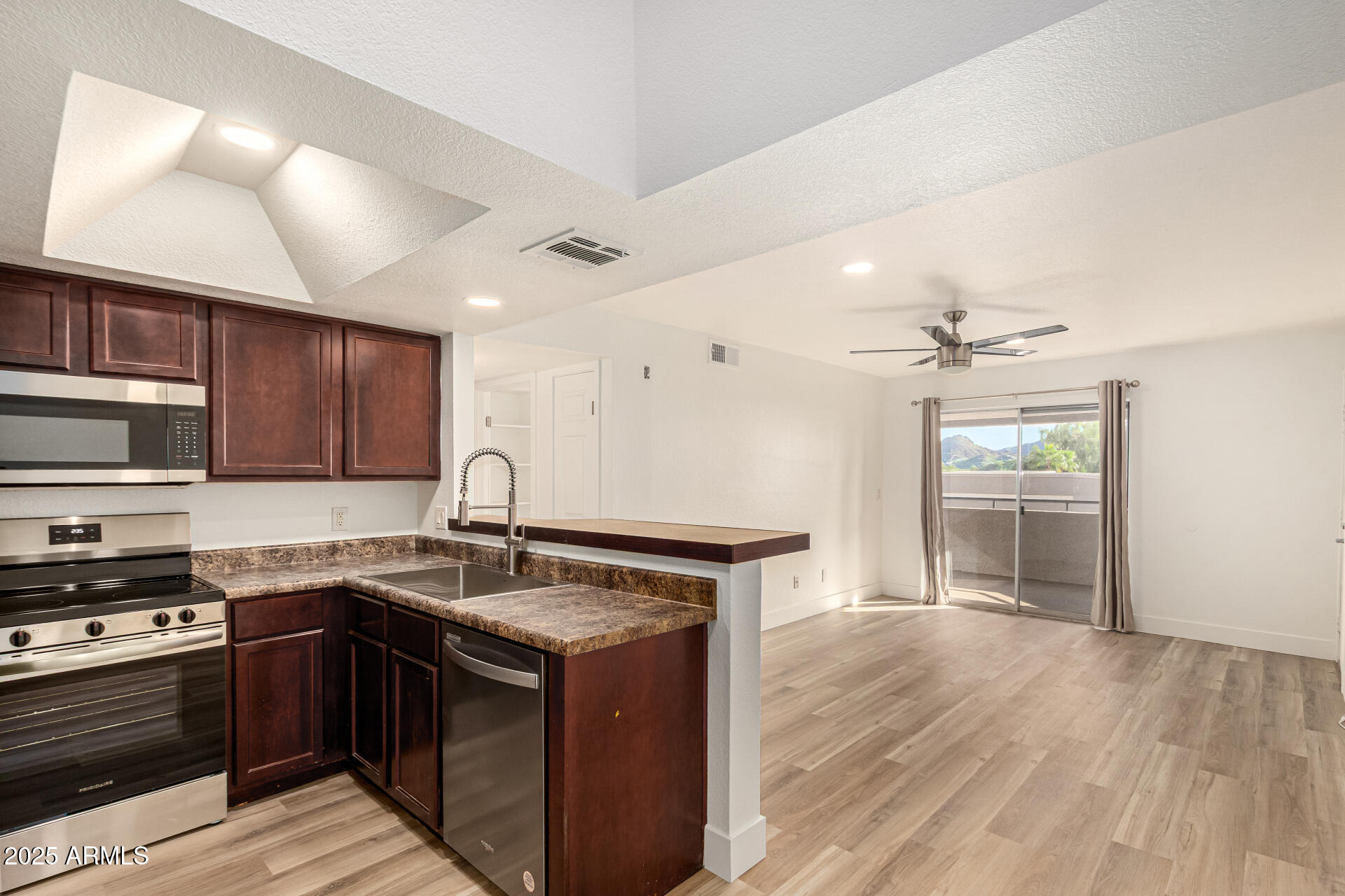 1720 East Thunderbird Road, Unit 2044 Phoenix, AZ 85022 - Photo 6 of 22 a kitchen with stainless steel appliances granite countertop a sink stove and cabinets