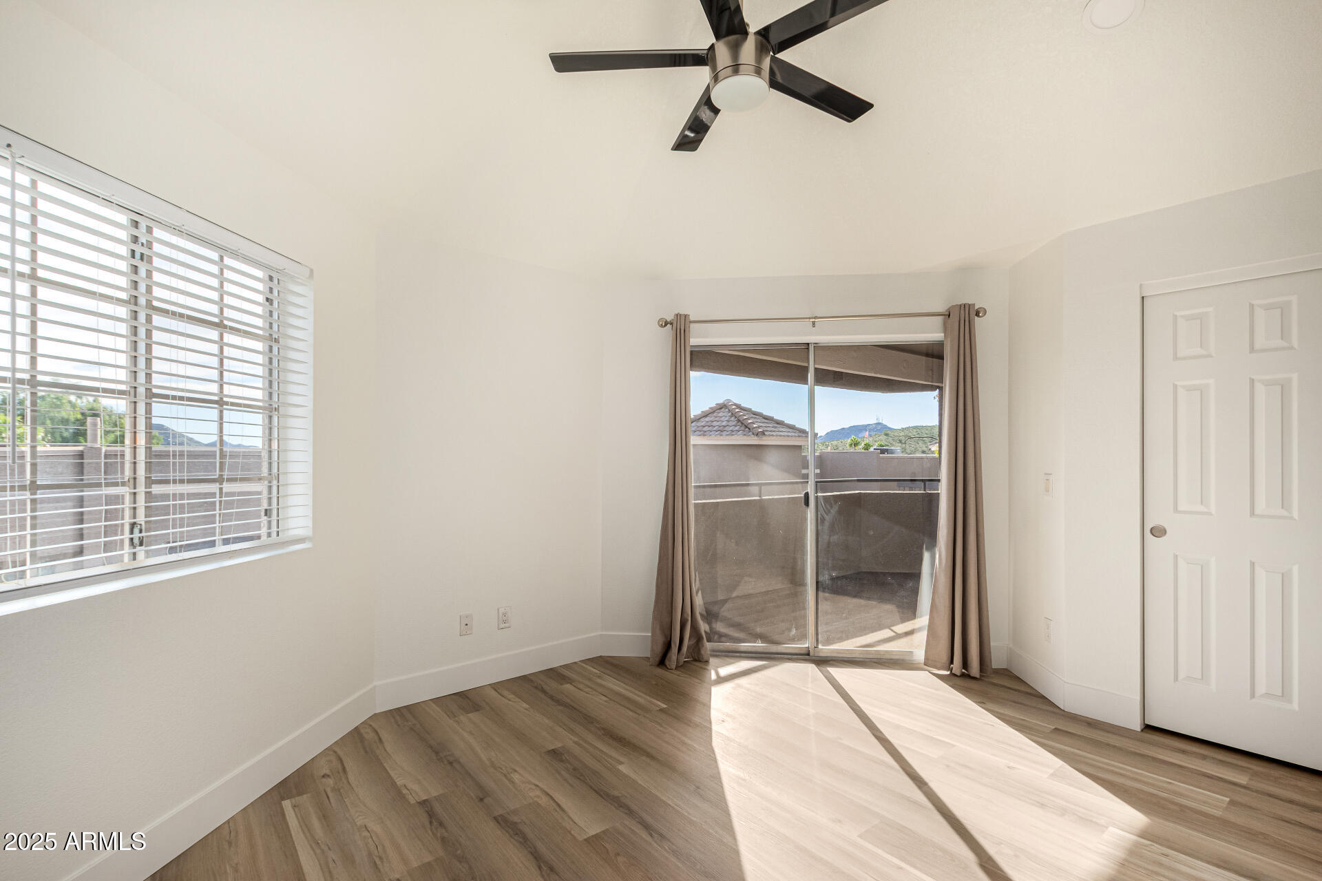 1720 East Thunderbird Road, Unit 2044 Phoenix, AZ 85022 - Photo 8 of 22 an empty room with wooden floor and windows
