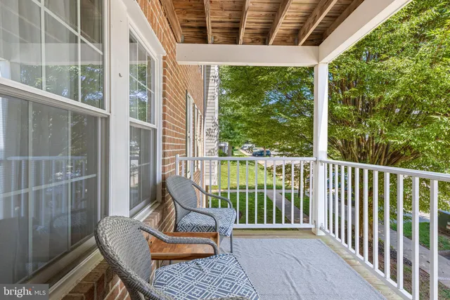 a view of a balcony with chair and floor to ceiling window