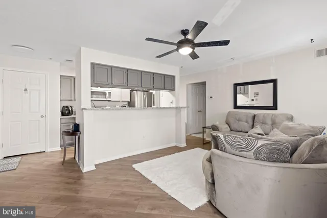 a living room with furniture and kitchen view