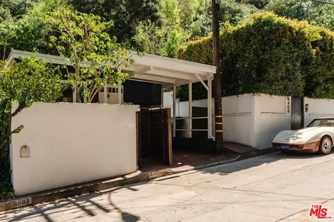 a side view of a house with parking space