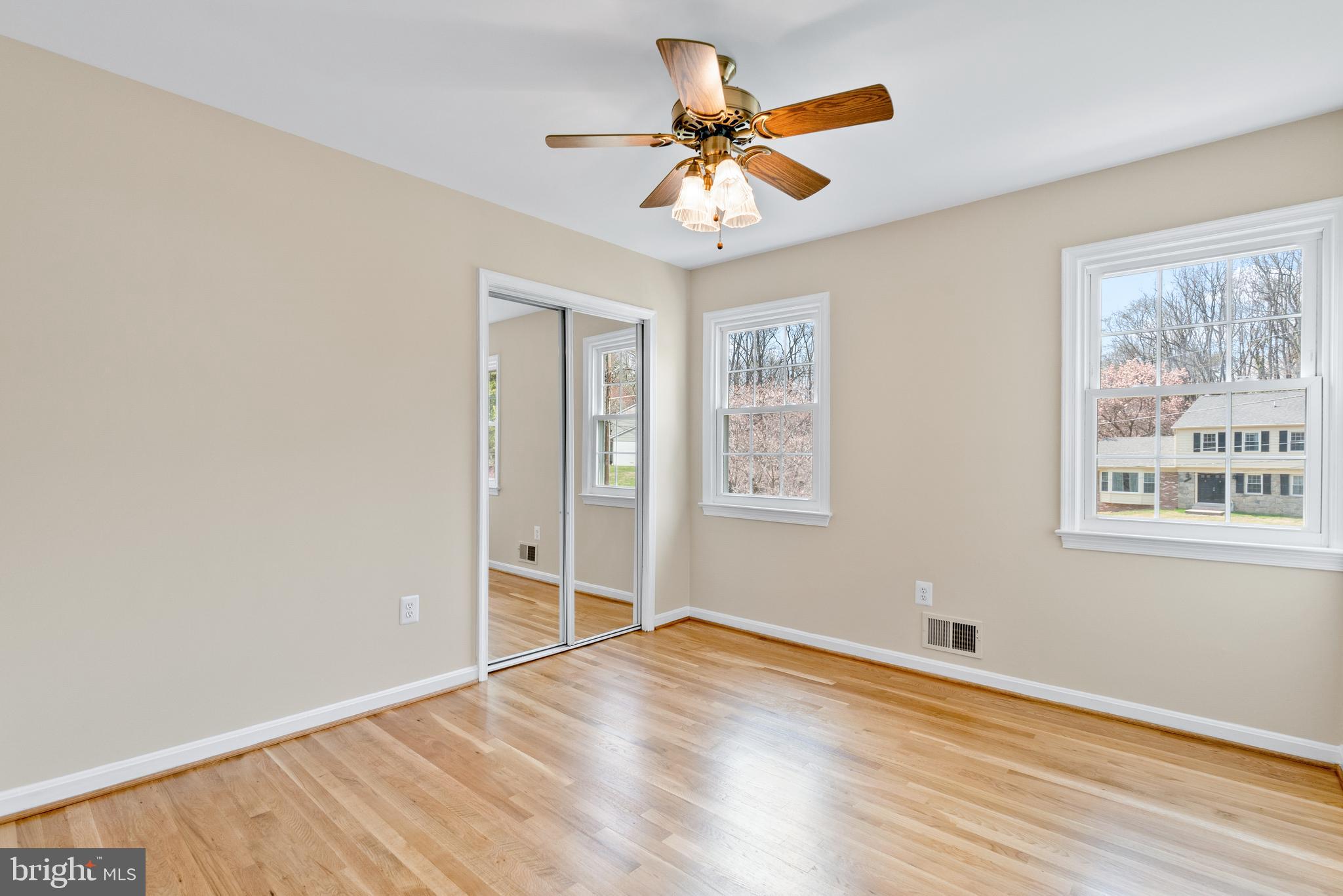 13605 Stoner Drive Silver Spring, MD 20904 - Photo 24 of 47 an empty room with wooden floor and windows