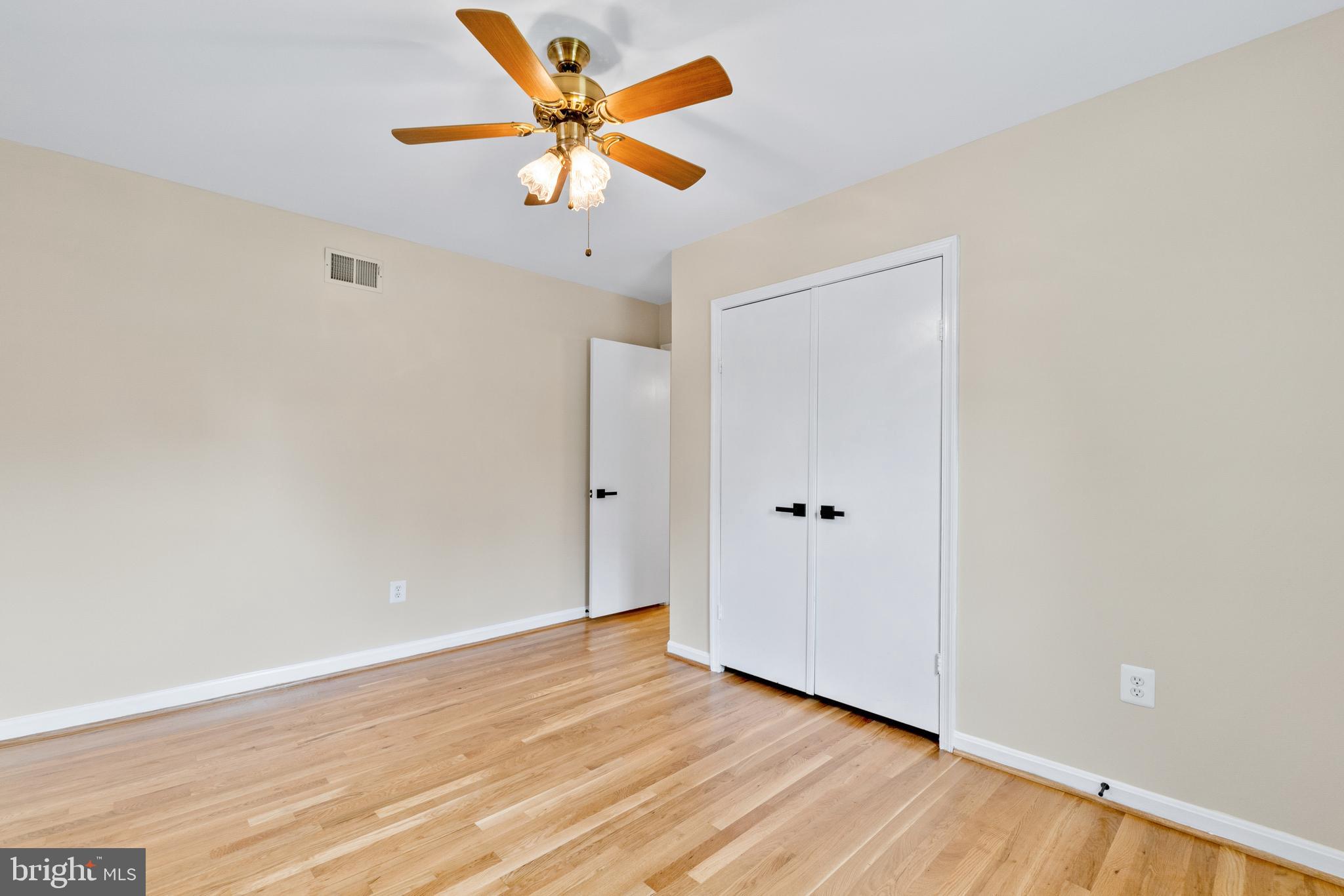 13605 Stoner Drive Silver Spring, MD 20904 - Photo 30 of 47 a view of a room with wooden floor and a ceiling fan