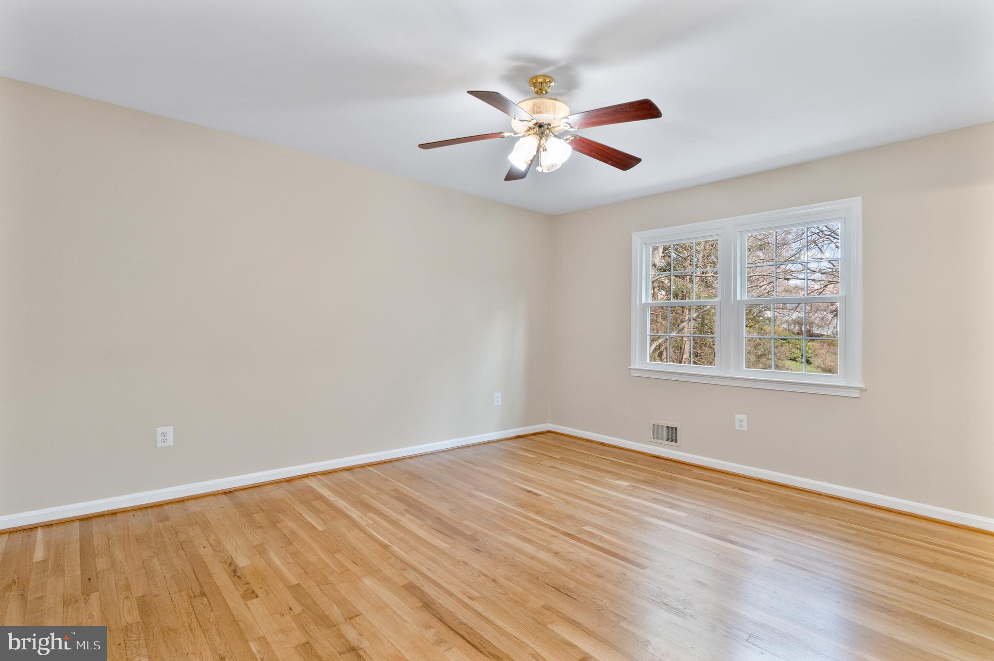 13605 Stoner Drive Silver Spring, MD 20904 - Photo 32 of 47 a view of an empty room with window and wooden floor