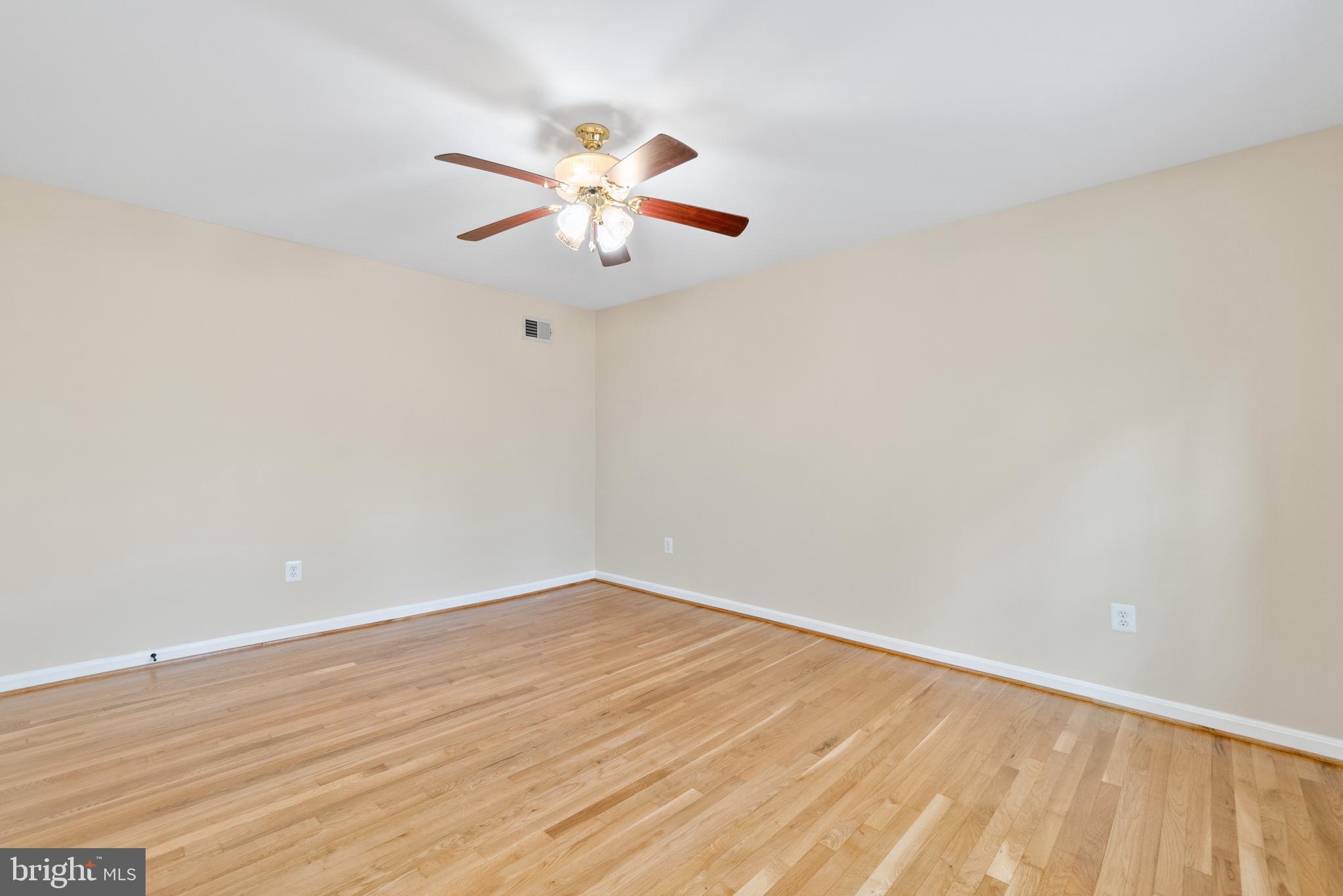 13605 Stoner Drive Silver Spring, MD 20904 - Photo 34 of 47 a view of an empty room with wooden floor and a ceiling fan