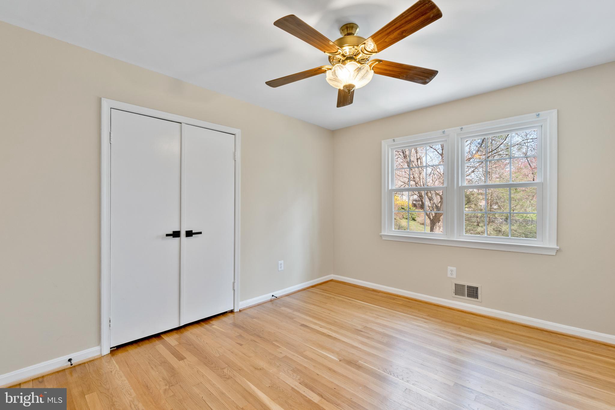 13605 Stoner Drive Silver Spring, MD 20904 - Photo 38 of 47 an empty room with wooden floor and windows