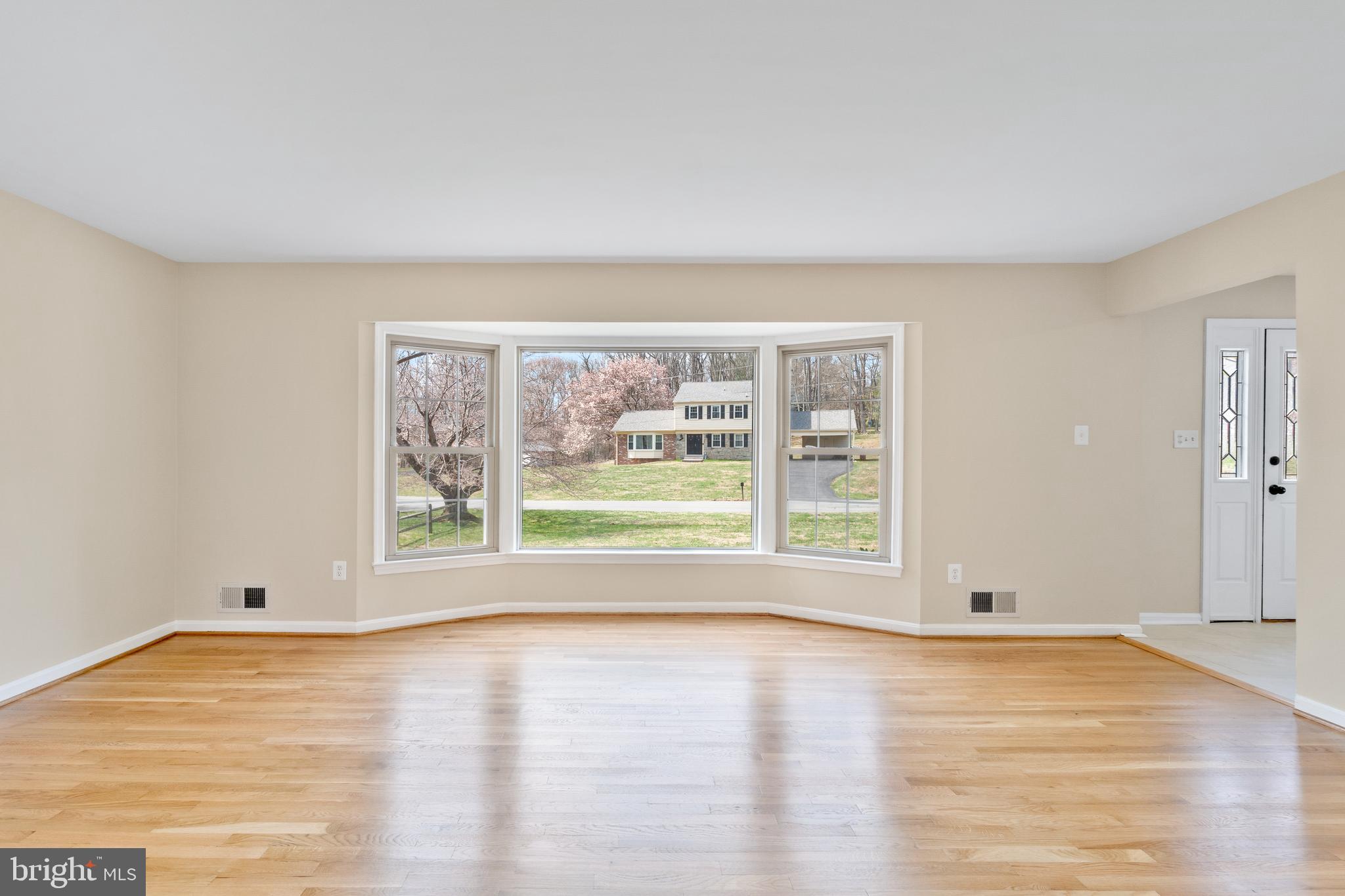 13605 Stoner Drive Silver Spring, MD 20904 - Photo 4 of 47 a view of an empty room with wooden floor and a window