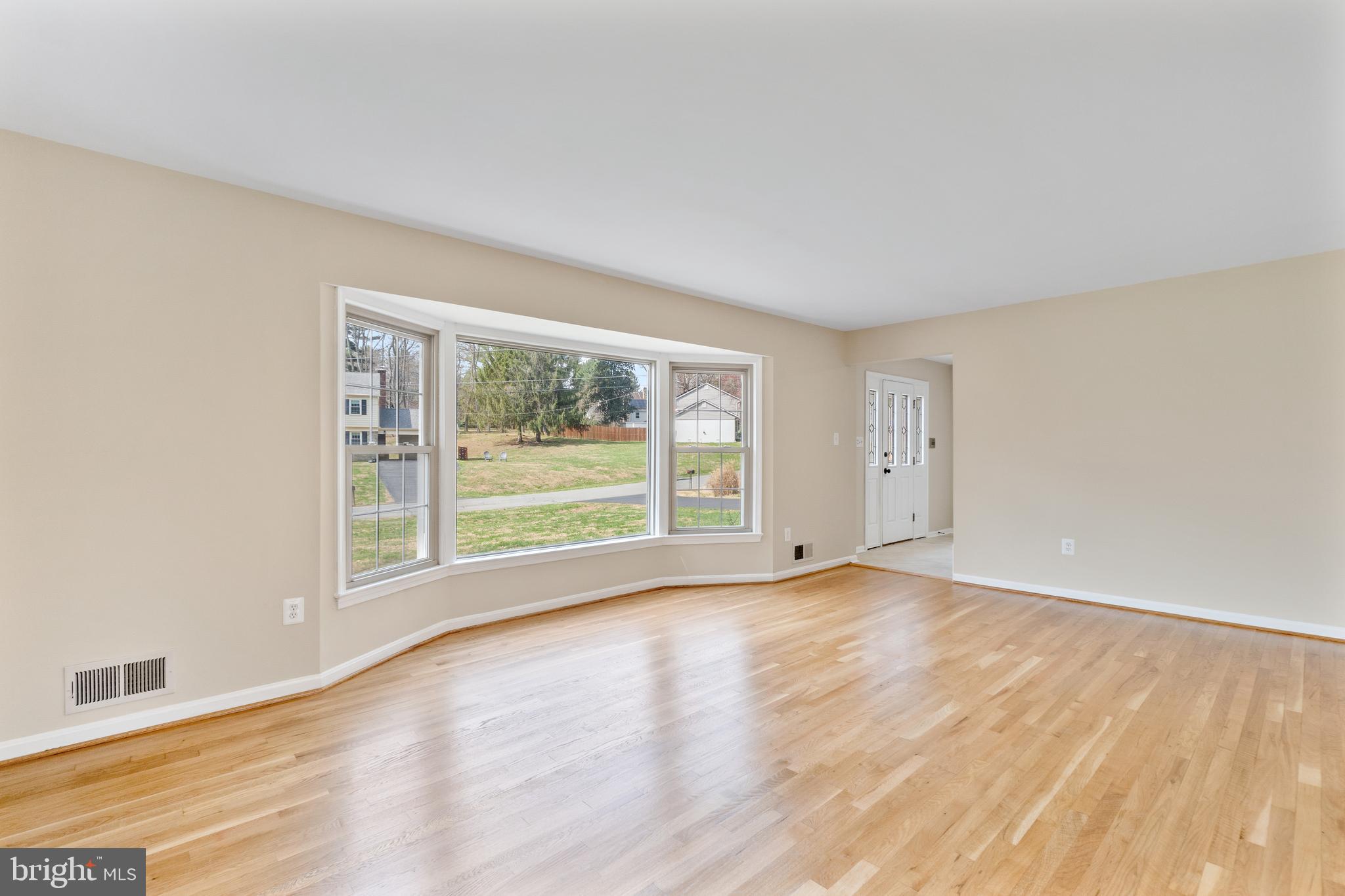 13605 Stoner Drive Silver Spring, MD 20904 - Photo 5 of 47 a view of an empty room with wooden floor and a window