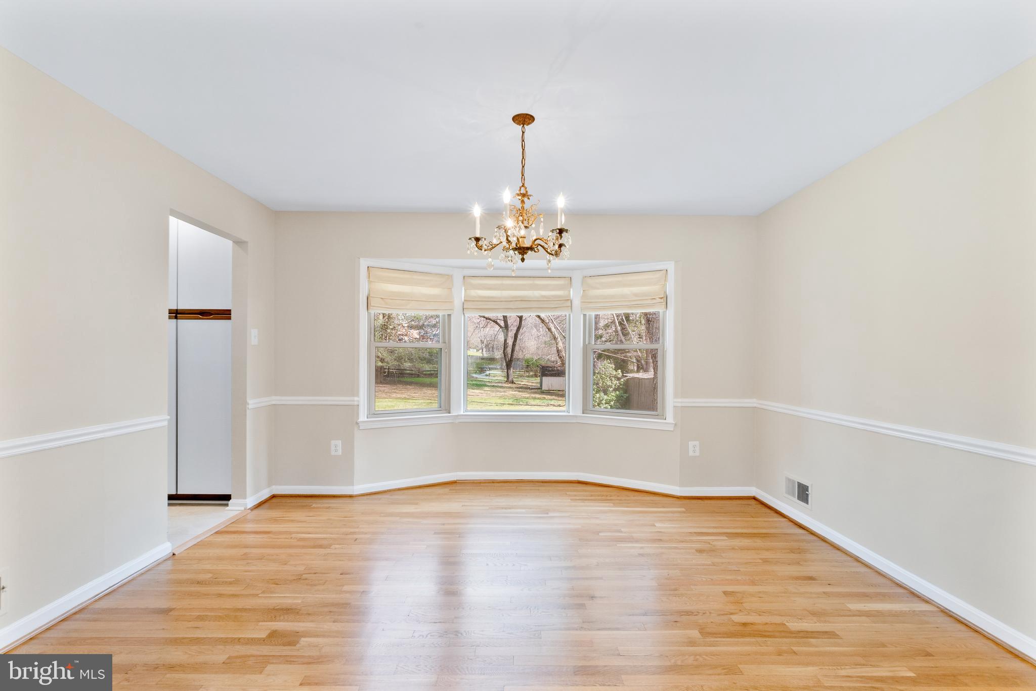 13605 Stoner Drive Silver Spring, MD 20904 - Photo 7 of 47 a view of an empty room with wooden floor and a window