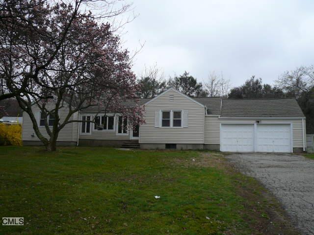 1263 Bronson Road Fairfield, CT 06824 - Photo 1 of 1 a front view of a house with a garden