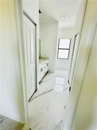 a view of a hallway to a room with stair