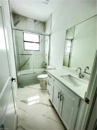a bathroom with a sink toilet and mirror
