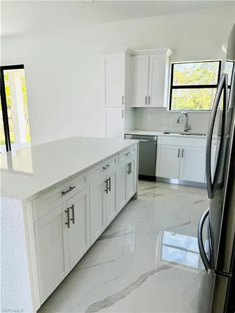 a kitchen with cabinets a sink and a window