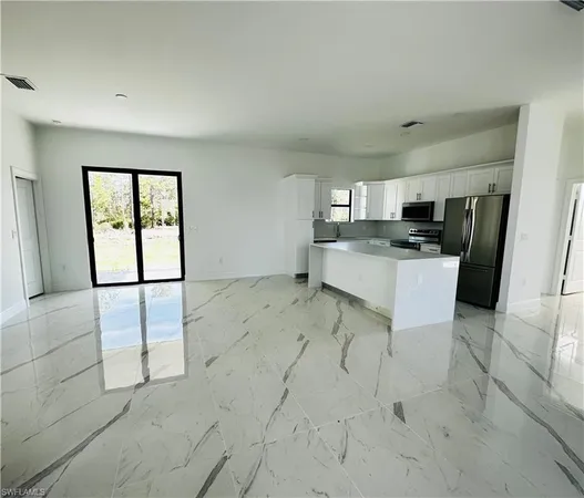 a kitchen with a stove a sink and a refrigerator