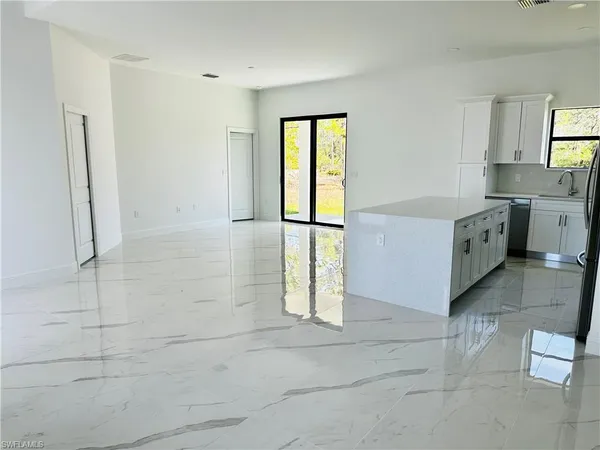 a kitchen with stainless steel appliances granite countertop a refrigerator and a stove