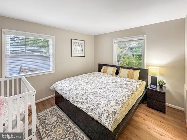 a bed sitting in a bedroom next to a window