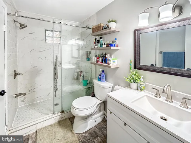 a bathroom with a sink toilet and shower
