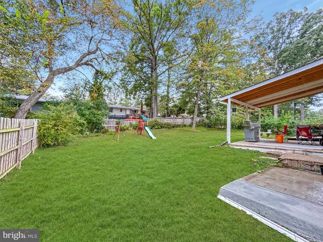 a view of a backyard with a garden and trees