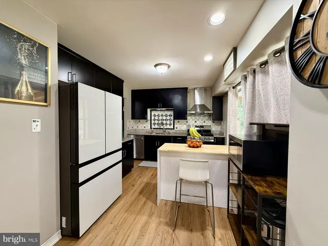 a kitchen with a sink appliances and cabinets