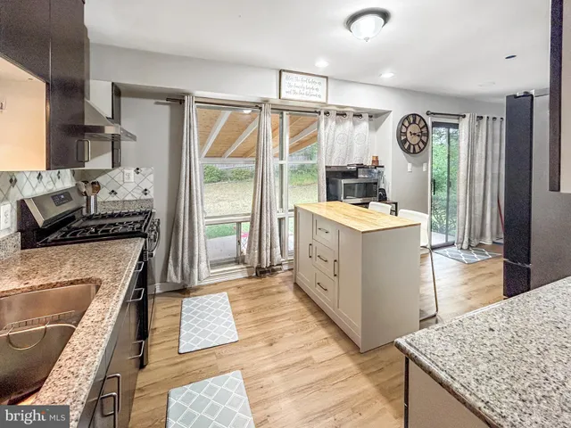 a kitchen with a stove a refrigerator and a oven