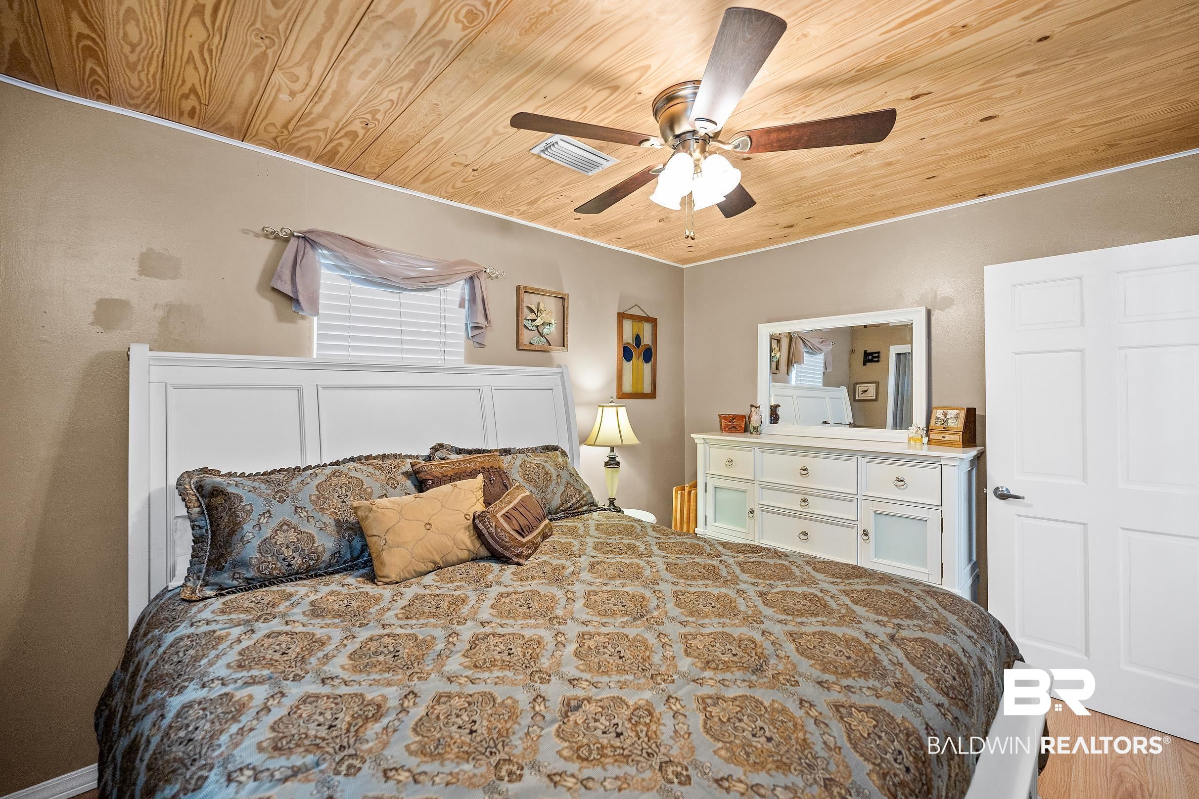 110 Sam Jones Road Atmore, AL 36502 - Photo 21 of 47 Bedroom with wooden ceiling, ceiling fan, and light wood-style flooring