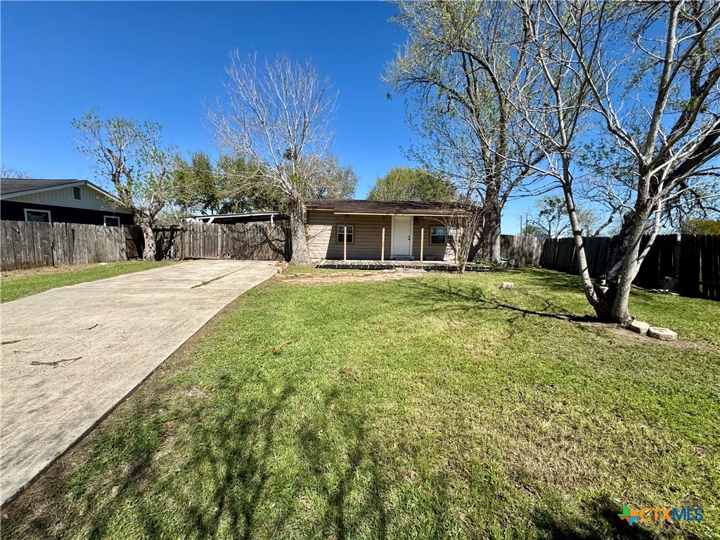 4904 Lone Tree Road Victoria, TX 77901 - Photo 11 of 13 a front view of a house with a yard and trees