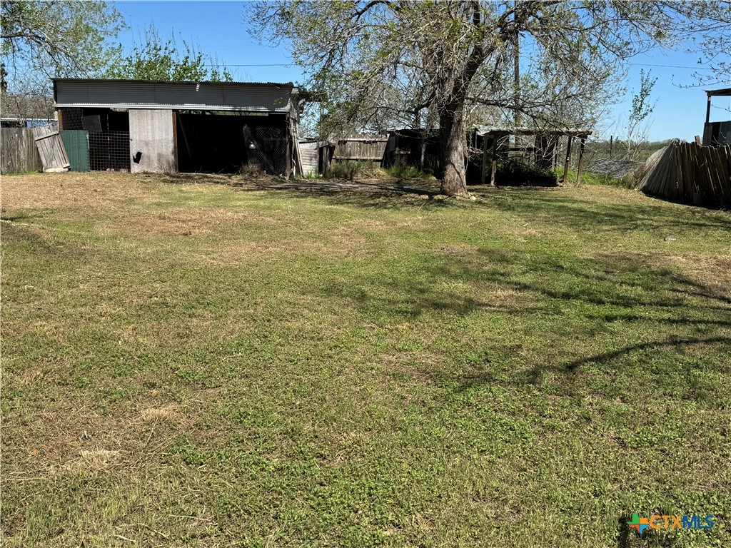 4904 Lone Tree Road Victoria, TX 77901 - Photo 12 of 13 a view of a house with backyard and trees