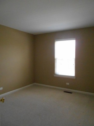 3040 Crystal Rock Road, Unit 3040 Naperville, IL 60564 - Photo 13 of 22 an empty room with a window