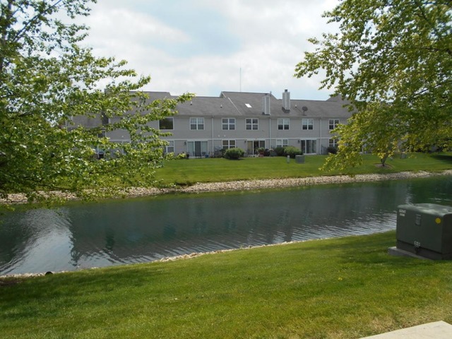 3040 Crystal Rock Road, Unit 3040 Naperville, IL 60564 - Photo 22 of 22 a view of a lake with a house in the background