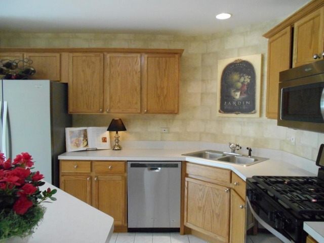 3040 Crystal Rock Road, Unit 3040 Naperville, IL 60564 - Photo 5 of 22 a kitchen with a sink a stove and cabinets