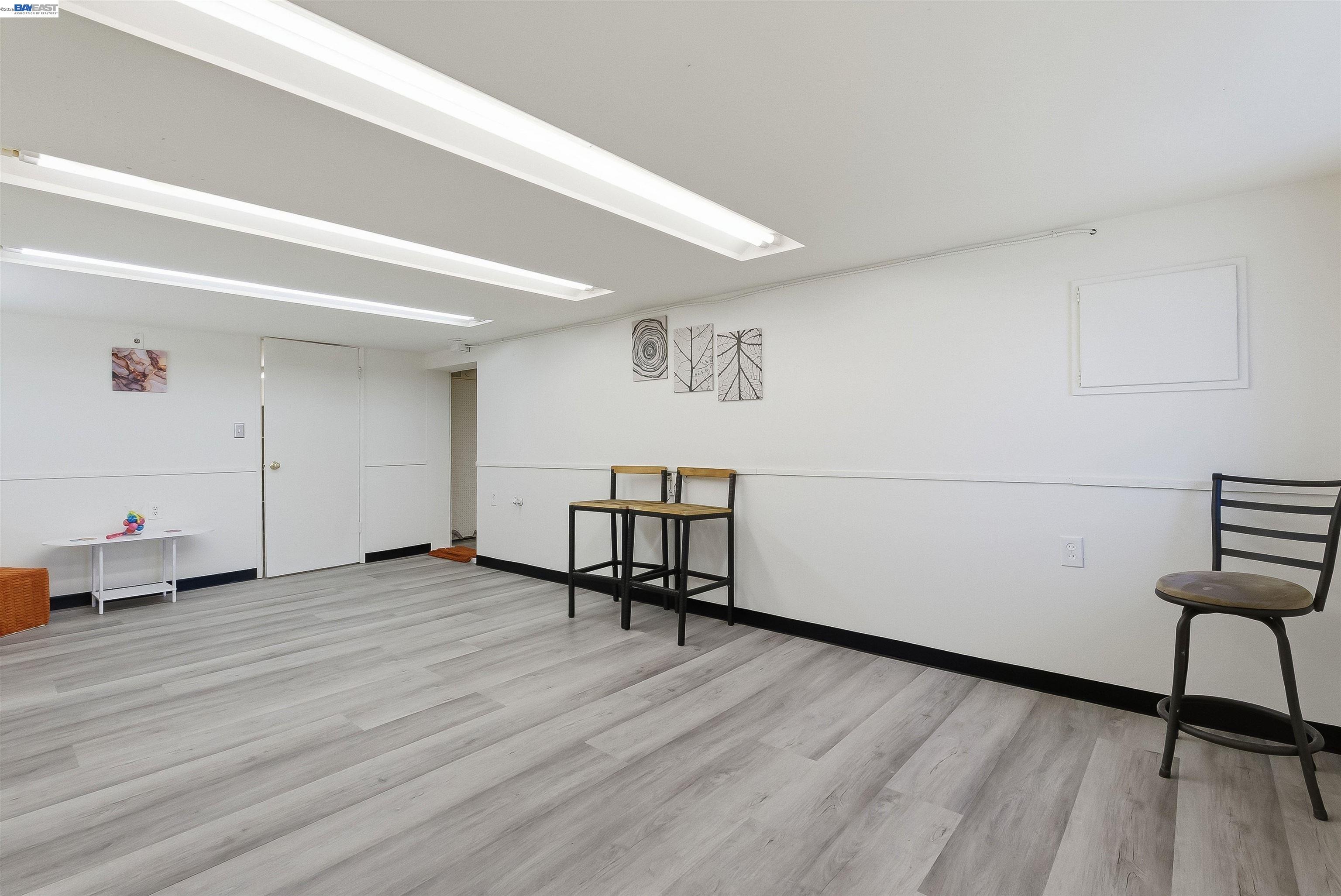 2049 Rutherford Street Oakland, CA 94601 - Photo 28 of 43 1st large room with new flooring. Potential kitchen/living/dining room