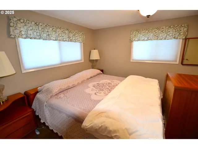 a bedroom with a bed and a mirror