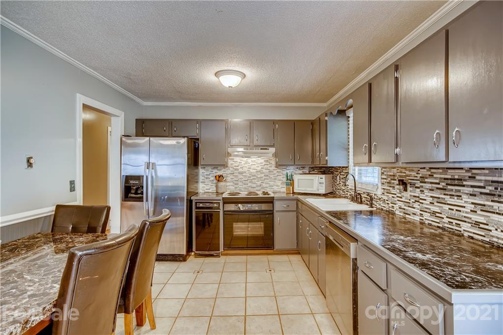 124 Riley Road Dallas, NC 28034 - Photo 2 of 9 a kitchen with stainless steel appliances granite countertop a sink stove and refrigerator