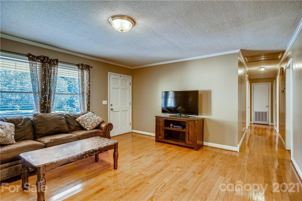 124 Riley Road Dallas, NC 28034 - Photo 3 of 9 a living room with furniture and a flat screen tv