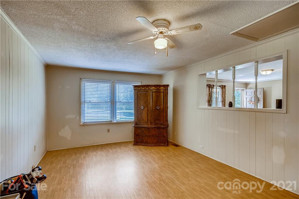 124 Riley Road Dallas, NC 28034 - Photo 5 of 9 a view of an empty room with a window and wooden floor