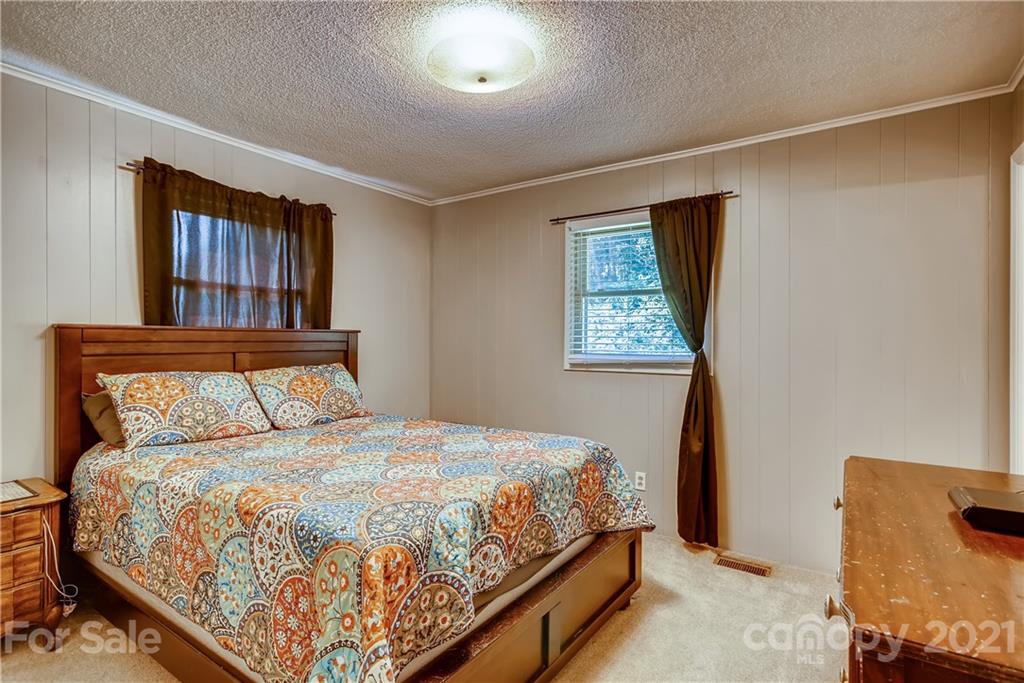 124 Riley Road Dallas, NC 28034 - Photo 6 of 9 a large bed sitting in a bedroom next to a window