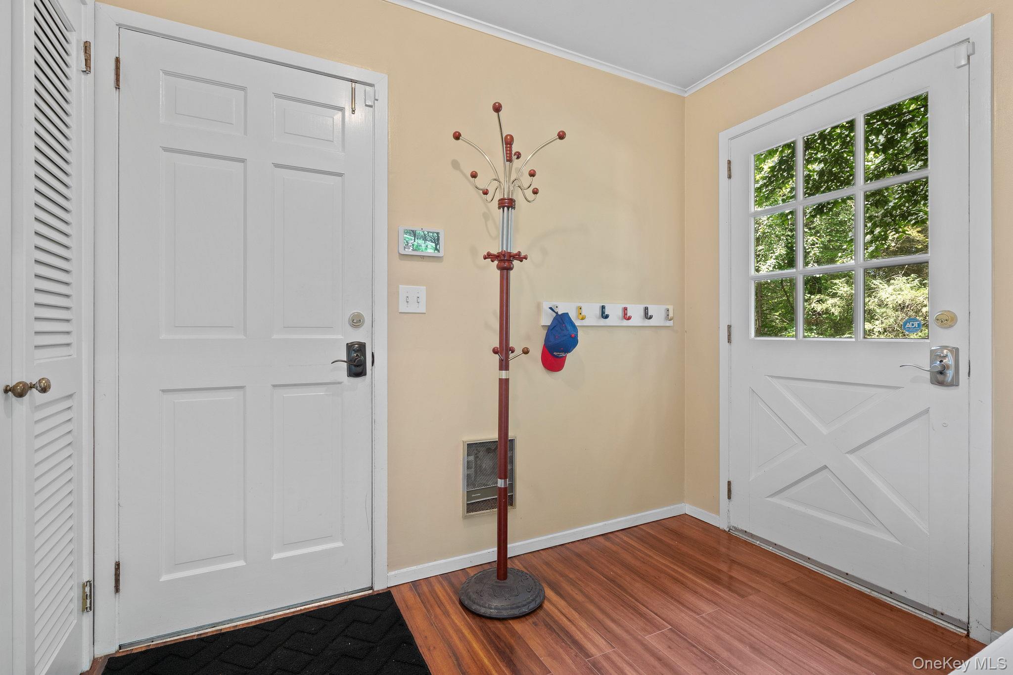 342 Woodbury Road Cold Spring Harbor, NY 11724 - Photo 14 of 29 a view of a hallway with wooden floor and staircase